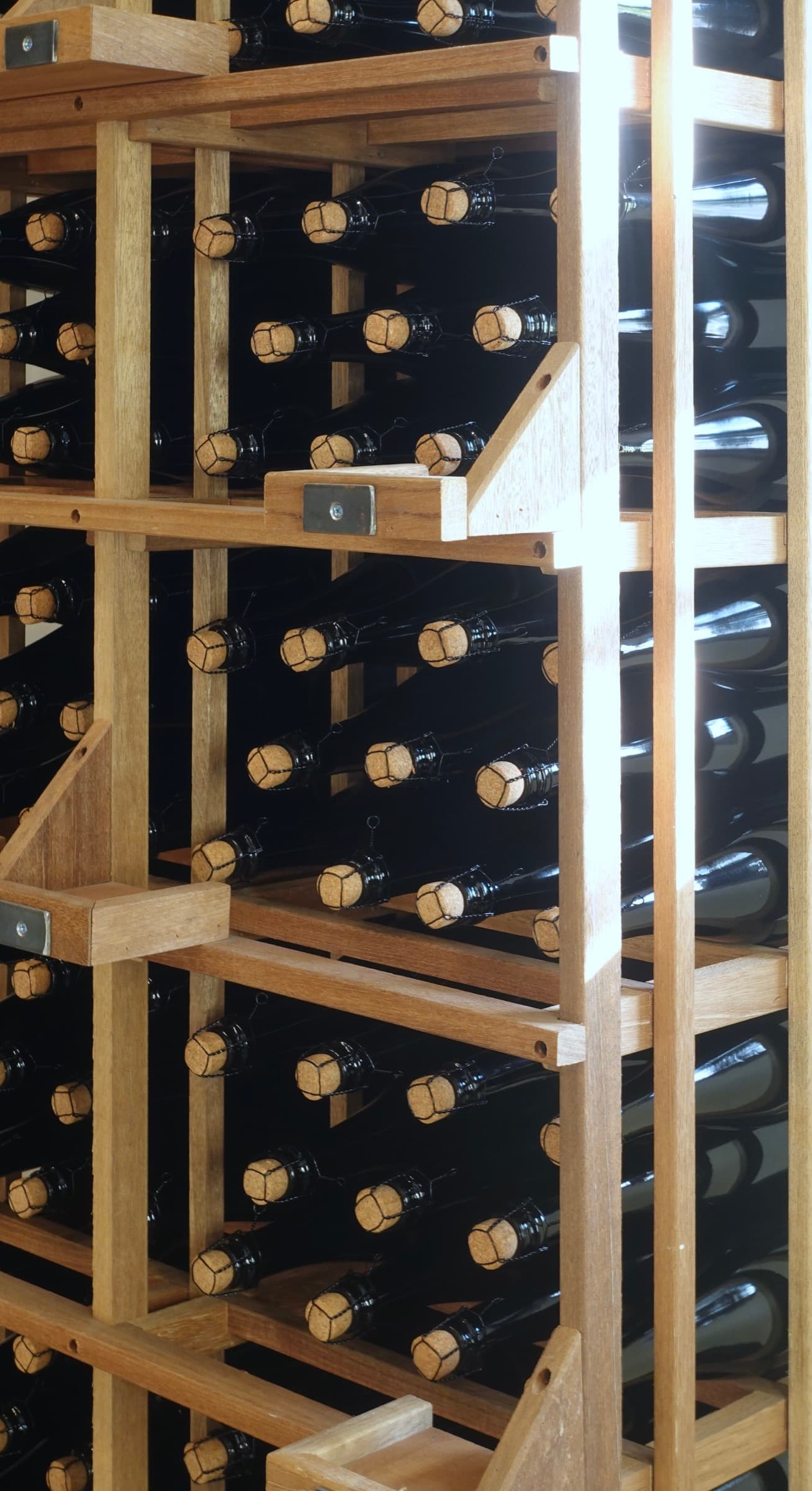 Corked bottles resting in wooden racks